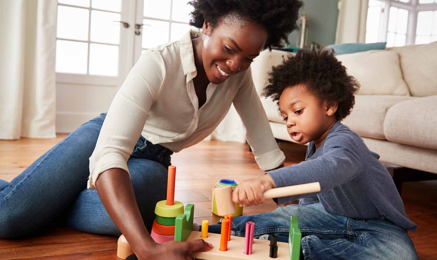 Parent and young child learning through play with colorful blocks